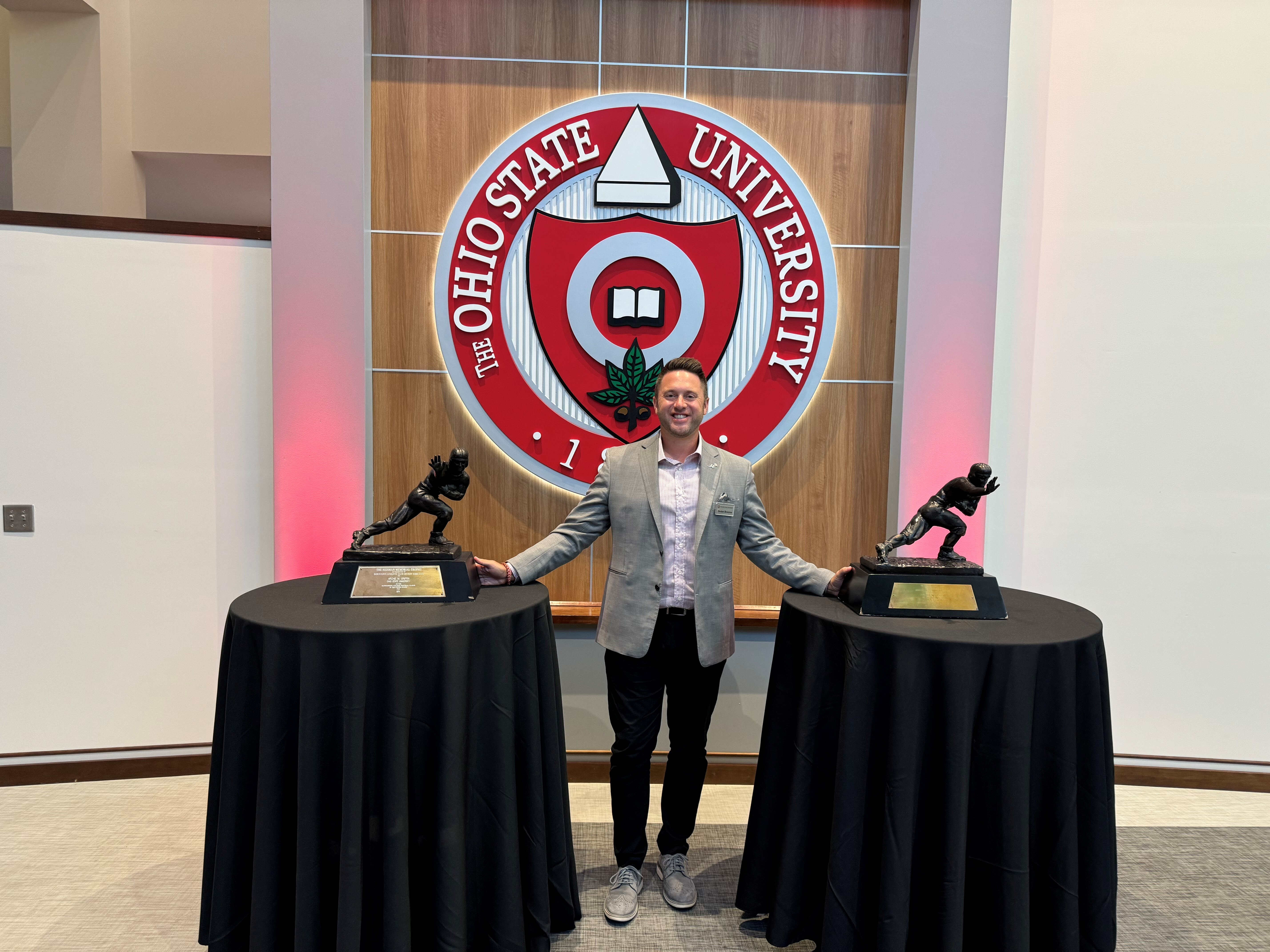 Dedan Brozino with Heisman Trophies